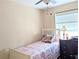 Comfortable bedroom with a large window and dark wood desk at 5918 Palm Ln # C33, Bradenton, FL 34207
