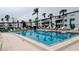 Inviting community pool surrounded by lounge chairs and palm trees, offering a relaxing atmosphere at 5918 Palm Ln # C33, Bradenton, FL 34207