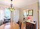 Cozy dining area featuring a round wood table, Tiffany-style chandelier, and a view into the kitchen at 5918 Palm Ln # C33, Bradenton, FL 34207