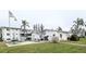Exterior view of the community buildings showcasing a barbecue area, picnic tables, and mature landscaping at 5918 Palm Ln # C33, Bradenton, FL 34207