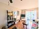 Comfortable living room with decor, TV, sliding glass doors to the outside and laminate wood floor at 5918 Palm Ln # C33, Bradenton, FL 34207