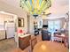 View of kitchen and open living space with wood floors, ceiling fan, and sliding doors to the outside at 5918 Palm Ln # C33, Bradenton, FL 34207
