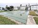 Community shuffleboard court with white condo buildings and palm trees in the background at 5918 Palm Ln # C33, Bradenton, FL 34207