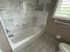 Bathroom features marble tiles, large tub and bright window at 600 S Neponsit Dr, Venice, FL 34293
