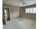 Bedroom featuring a ceiling fan, window with shutters, and an adjacent bathroom at 600 S Neponsit Dr, Venice, FL 34293