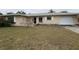 Single story home featuring a two car garage and a lawn in need of maintenance at 600 S Neponsit Dr, Venice, FL 34293