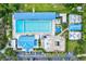 Aerial view of the YMCA with multiple pools, a playground, and parking at 7453 Featherstone Blvd, Sarasota, FL 34238