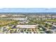 Expansive aerial view showcasing the community's layout and proximity to natural surroundings with neighborhood houses and parks at 7453 Featherstone Blvd, Sarasota, FL 34238