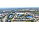 Stunning aerial shot of the residential neighborhood featuring lake views, houses, and lush green landscaping at 7453 Featherstone Blvd, Sarasota, FL 34238