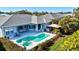 Inviting backyard oasis with a private pool, patio area, and lush landscaping; perfect for outdoor entertaining at 7453 Featherstone Blvd, Sarasota, FL 34238