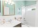 Bathroom featuring a white vanity, subway tile and a shower-tub combo at 7453 Featherstone Blvd, Sarasota, FL 34238