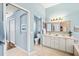 Bright bathroom features dual sinks, a large mirror, and neutral tones creating a spa-like atmosphere at 7453 Featherstone Blvd, Sarasota, FL 34238