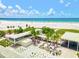 Bright aerial view of a bustling beach with turquoise waters and clear blue sky at 7453 Featherstone Blvd, Sarasota, FL 34238