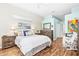 Serene primary bedroom with wood floors, accent wall, and natural light at 7453 Featherstone Blvd, Sarasota, FL 34238