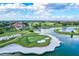 Expansive aerial view of a lush golf course with water hazards and a clubhouse in the distance at 7453 Featherstone Blvd, Sarasota, FL 34238