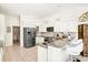 Modern kitchen featuring stainless steel appliances, granite countertops, and ample cabinet space with barstool seating at 7453 Featherstone Blvd, Sarasota, FL 34238