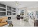 Spacious living room featuring a fireplace, built-in shelving, and sliding doors that overlook the pool at 7453 Featherstone Blvd, Sarasota, FL 34238