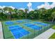 Overhead view of outdoor pickleball courts with green and blue surfacing at 7453 Featherstone Blvd, Sarasota, FL 34238