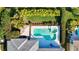 Aerial shot of a pristine pool with attached spa, manicured landscaping, and an outdoor gazebo at 7453 Featherstone Blvd, Sarasota, FL 34238