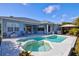 Stunning pool and spa with landscaped surroundings and a cozy outdoor seating area at 7453 Featherstone Blvd, Sarasota, FL 34238