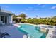 Lovely backyard featuring a swimming pool, spa, lush landscaping, and an inviting gazebo at 7453 Featherstone Blvd, Sarasota, FL 34238