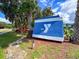Street view of the YMCA sign surrounded by trees and landscaping at 7453 Featherstone Blvd, Sarasota, FL 34238
