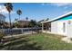 Large backyard with a dock, grass, and a view of the water at 765 Saint Judes N Dr, Longboat Key, FL 34228