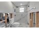 Renovated bathroom with a frameless glass shower enclosure and marble tiling at 765 Saint Judes N Dr, Longboat Key, FL 34228