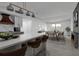 Modern kitchen and dining area featuring an island, stainless steel appliances, and a cozy fireplace at 765 Saint Judes N Dr, Longboat Key, FL 34228
