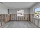 Bright living room featuring wood-look flooring and windows with views of palm trees at 765 Saint Judes N Dr, Longboat Key, FL 34228