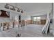 Living room area with hardwood floors, white walls, and a stone fireplace at 765 Saint Judes N Dr, Longboat Key, FL 34228