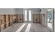 Bright living room featuring wood-look flooring and windows and patio doors at 765 Saint Judes N Dr, Longboat Key, FL 34228