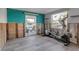 Bright living room featuring wood-look flooring and a door leading to a patio at 765 Saint Judes N Dr, Longboat Key, FL 34228