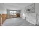 Open floor plan with light gray wood flooring and a stone fireplace at 765 Saint Judes N Dr, Longboat Key, FL 34228