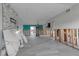Bright and airy open floor plan with gray wood floors, a stone fireplace, and a view to the pool at 765 Saint Judes N Dr, Longboat Key, FL 34228
