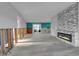 Open-concept living room featuring a modern fireplace, turquoise accent wall, and renovation potential at 765 Saint Judes N Dr, Longboat Key, FL 34228