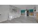 Large living room with an electric fireplace and light gray wood floors at 765 Saint Judes N Dr, Longboat Key, FL 34228
