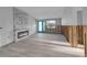 Inviting living room with a modern fireplace, turquoise door, and open space ready for personalization at 765 Saint Judes N Dr, Longboat Key, FL 34228