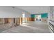 Bright, open-concept living room with a modern fireplace and turquoise accent wall, ready for renovation at 765 Saint Judes N Dr, Longboat Key, FL 34228