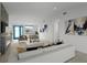 Bright living room featuring a fireplace, ample natural light, and modern decor at 765 Saint Judes N Dr, Longboat Key, FL 34228
