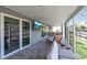 Enclosed patio offering canal views, comfortable lounge furniture, and an outdoor television at 765 Saint Judes N Dr, Longboat Key, FL 34228