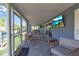 Outdoor covered patio with a table and chairs and a view of the water at 765 Saint Judes N Dr, Longboat Key, FL 34228