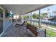 Outdoor patio with lots of comfortable furniture, a view of the water, and a mounted television at 765 Saint Judes N Dr, Longboat Key, FL 34228