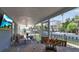 Enclosed patio with comfortable seating, a dining area, and tranquil canal views at 765 Saint Judes N Dr, Longboat Key, FL 34228