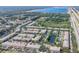 Aerial view of a community with ponds, lush landscaping, and surrounding nature at 1605 Napoli W Dr, Sarasota, FL 34232
