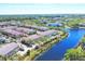 Community aerial view with waterways, greenery and residential buildings in the distance at 1605 Napoli W Dr, Sarasota, FL 34232