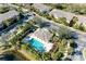Bird's eye view of pool area with seating surrounded by homes and lush landscaping at 1605 Napoli W Dr, Sarasota, FL 34232