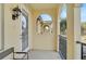 A serene, covered balcony with stucco arches, metal railings, and a tranquil view of palm trees and residential architecture at 1605 Napoli W Dr, Sarasota, FL 34232