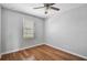 This bedroom features hardwood floors, a ceiling fan, and a window with blinds at 1605 Napoli W Dr, Sarasota, FL 34232