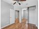 A bedroom featuring hardwood floors, large mirrored closet doors and a door to another room at 1605 Napoli W Dr, Sarasota, FL 34232